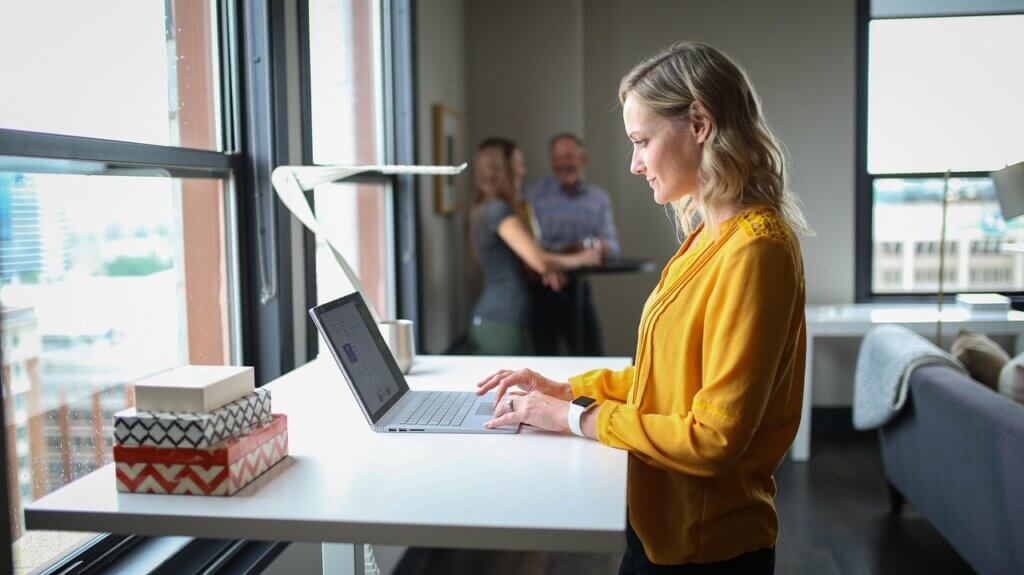 woman business owner at desk with laptop